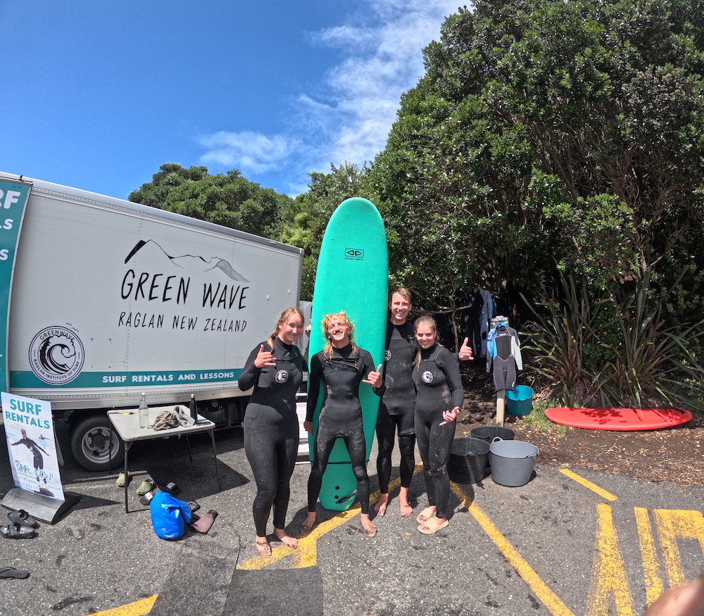 Green Wave Raglan surf team with boards